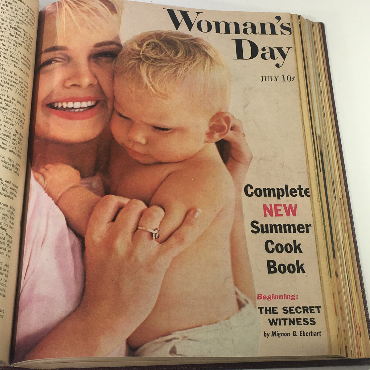 Cover image of the 1958 Woman's Day Magazine showing a mother holding her baby, featuring the title 'Complete New Summer Cook Book'.