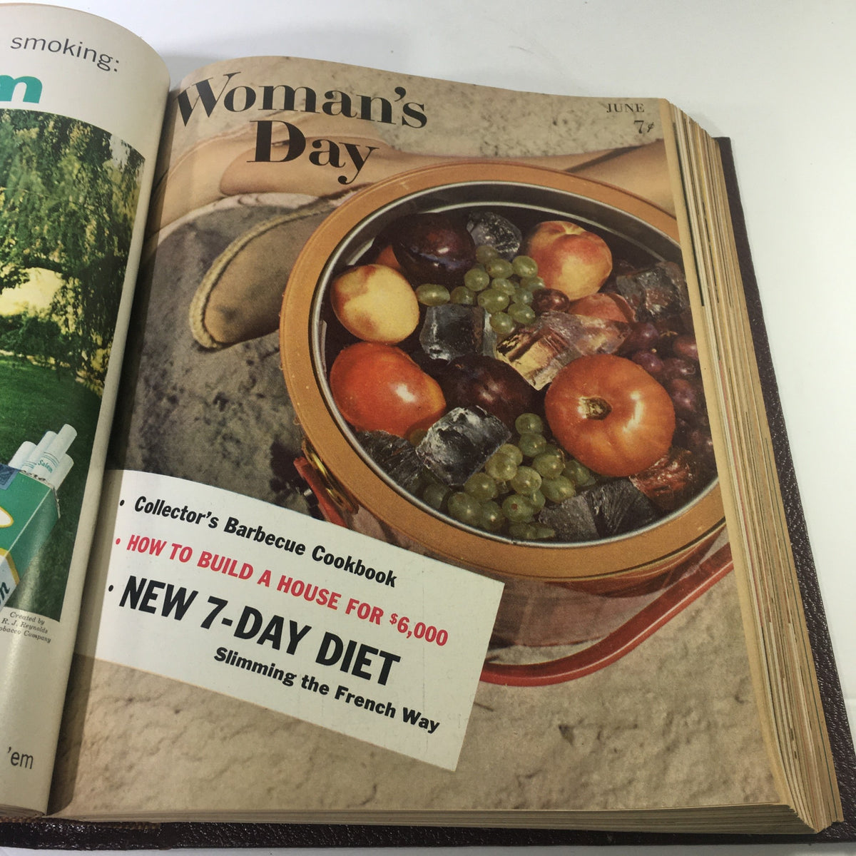 June 1957 cover of Woman's Day Magazine featuring a decorative container of fruits, promoting a barbecue cookbook and diet tips.