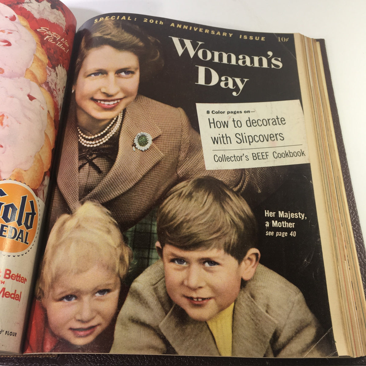 Cover of the 20th Anniversary issue of Woman's Day Magazine featuring a woman in a pearl necklace with children, introducing special anniversary content.