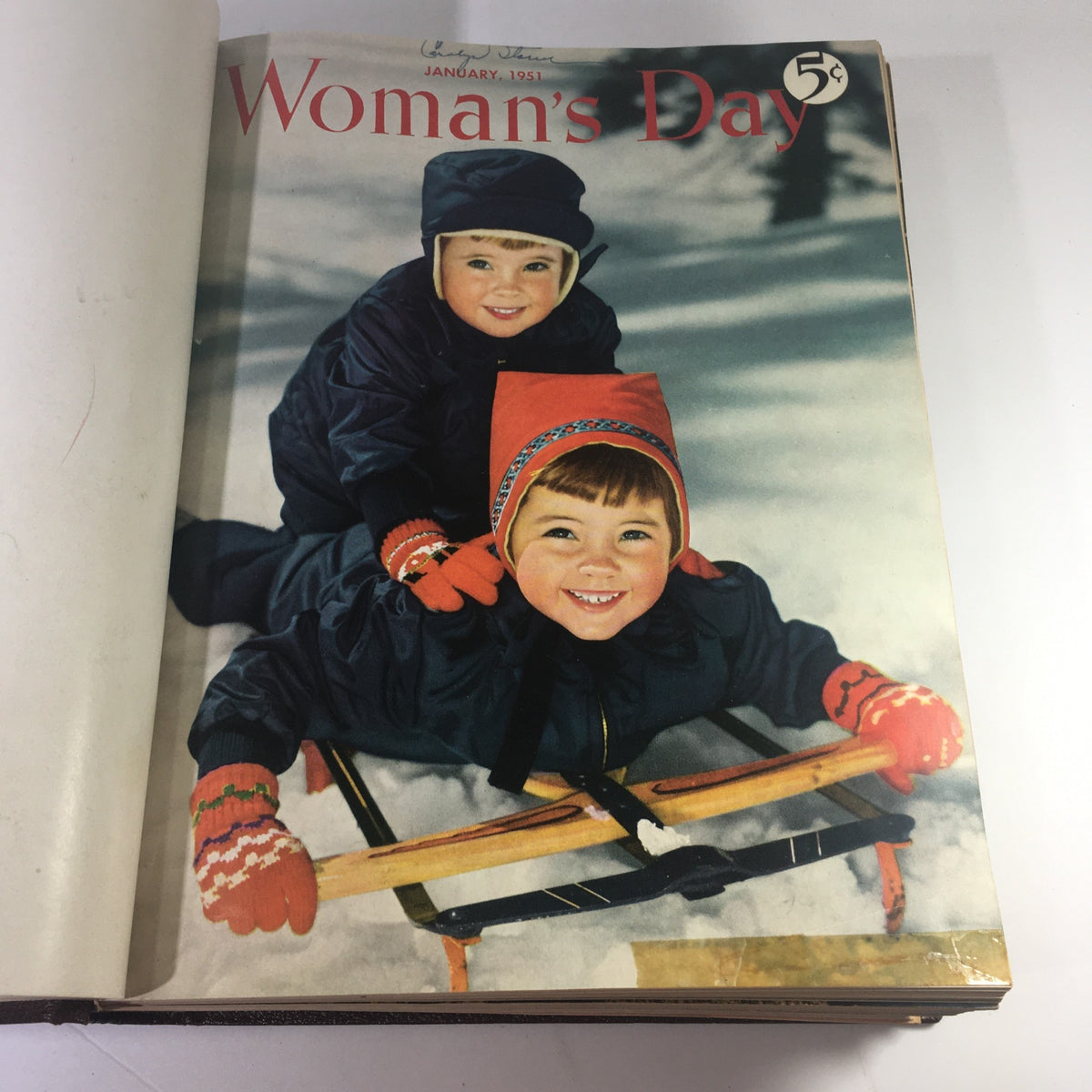 Cover page of the January 1951 issue of Woman's Day Magazine, featuring two children playing in the snow.