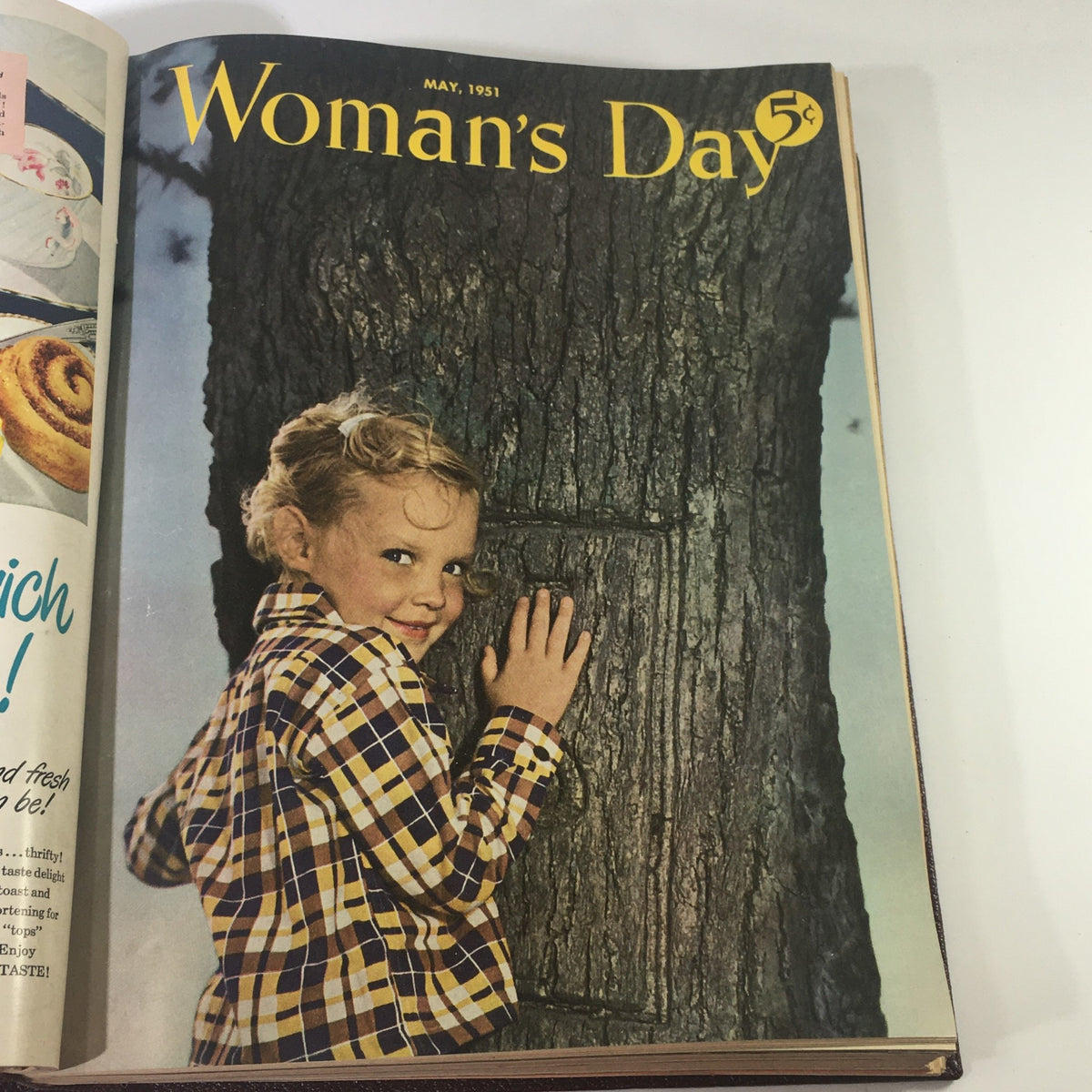 Cover of May 1951 Woman's Day Magazine showcasing a young girl beside a tree, exuding vintage charm.