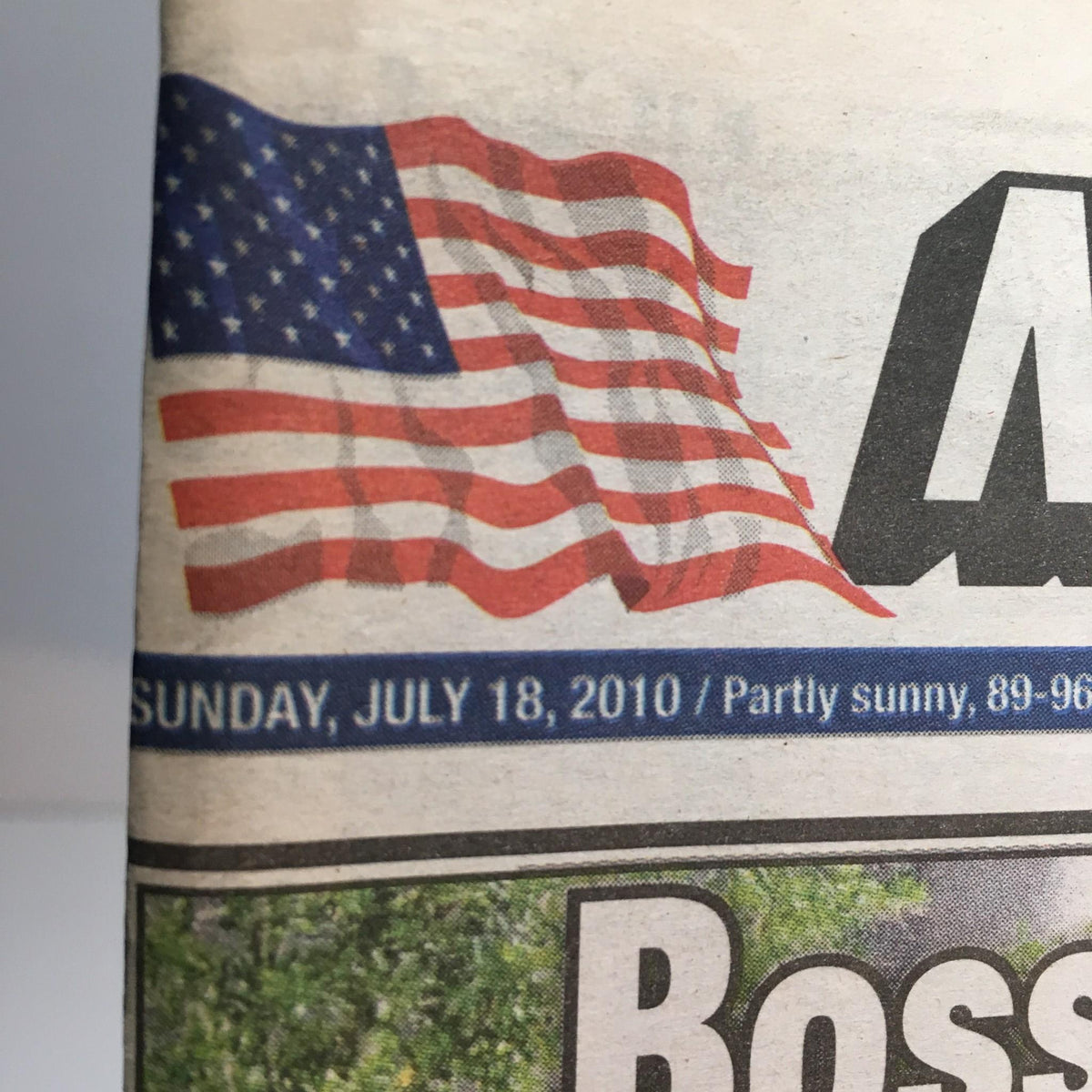 Close-up of the New York Post publication date banner, displaying 'Sunday, July 18, 2010' with an American flag graphic, emphasizing its historical value and cultural significance.