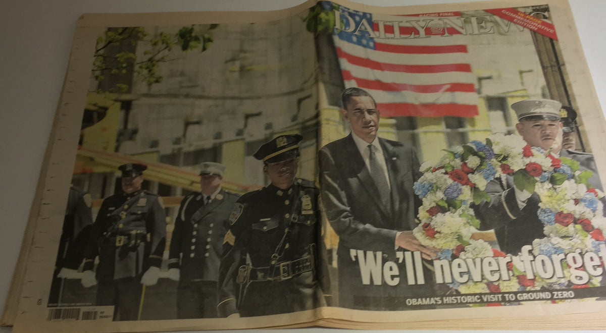 NY Daily News cover from May 6, 2011, featuring a historic image of Obama's visit to Ground Zero with a police officer and firefighters, captioned 'We'll Never Forget.'