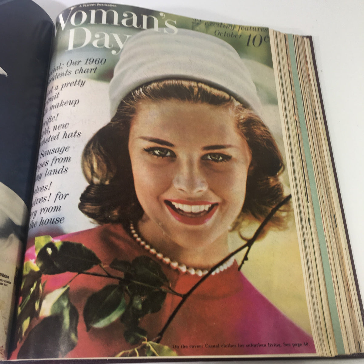 Cover of the 1960 Woman's Day Magazine featuring a smiling young woman in a stylish hat, capturing the essence of fashion and beauty trends of the era.