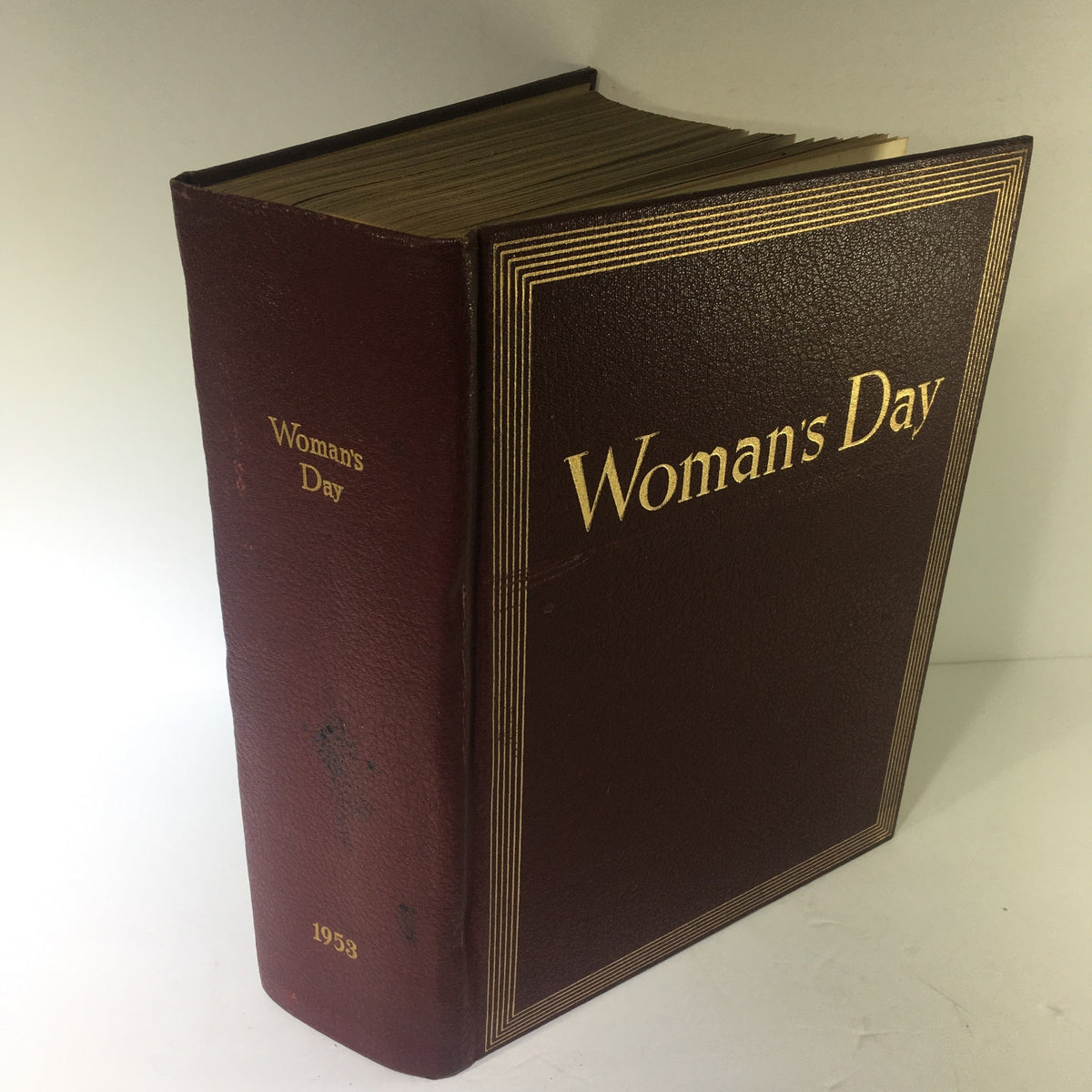 Cover of the 1953 Woman's Day Magazine Compilation featuring a rich maroon spine with gold lettering that reads 'Woman's Day' and '1953'.