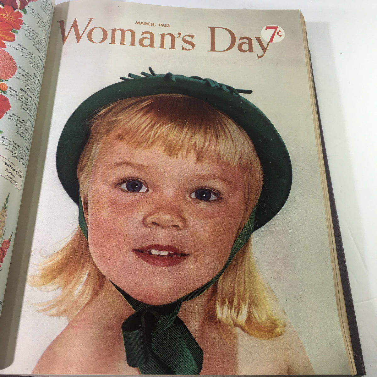 Cover of March 1953 Woman's Day magazine featuring a charming little girl with blonde hair wearing a green hat.
