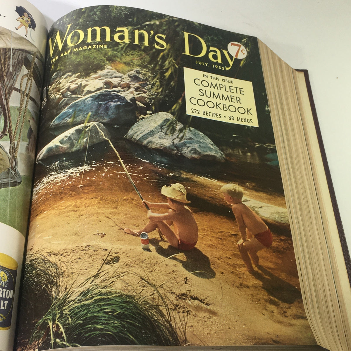 Cover of July 1953 Woman's Day magazine featuring two children fishing by a river during summer.