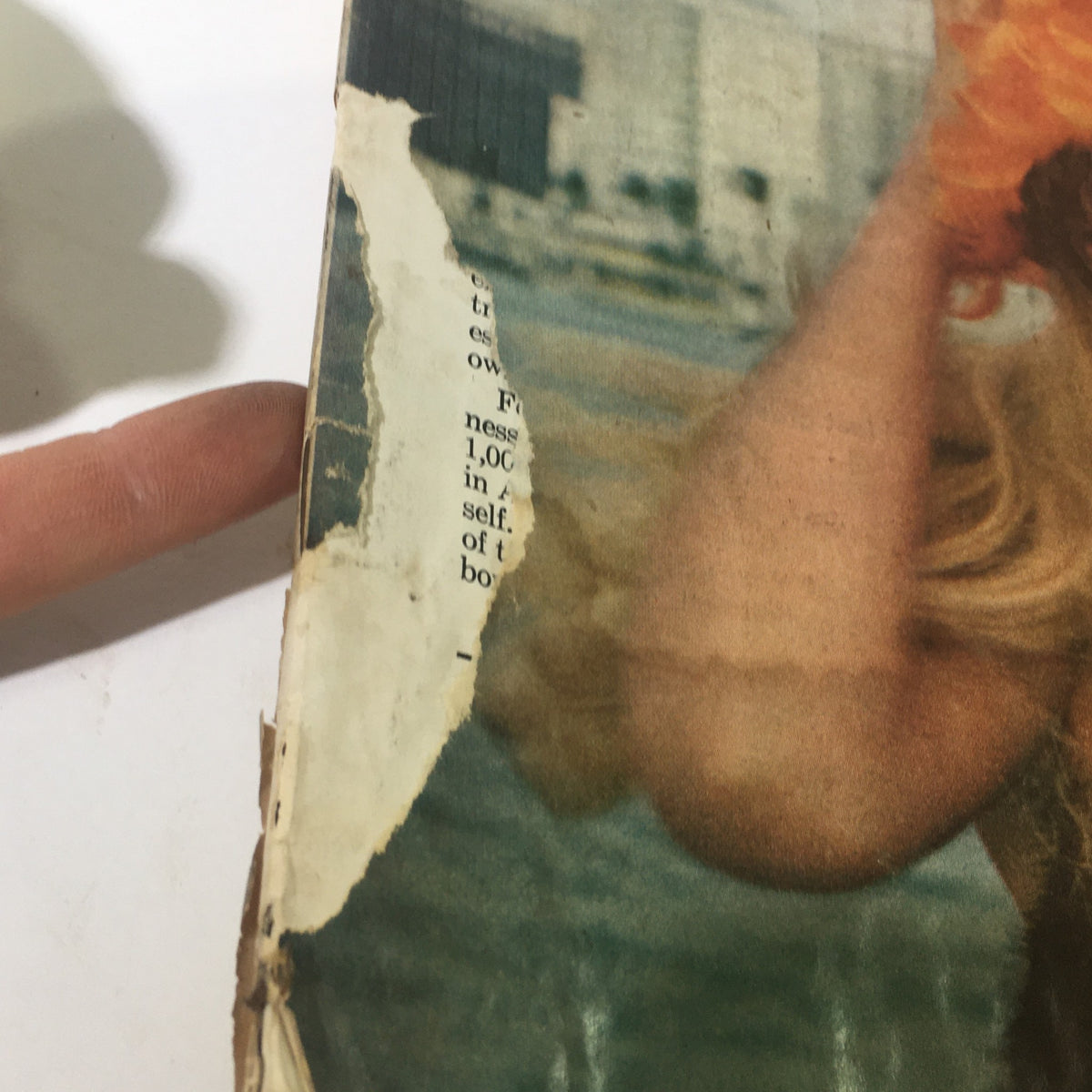 Detail of the cover of VTG The Saturday Evening Post February 26, 1966 showing a torn edge and the woman's arm wearing an orange hat.