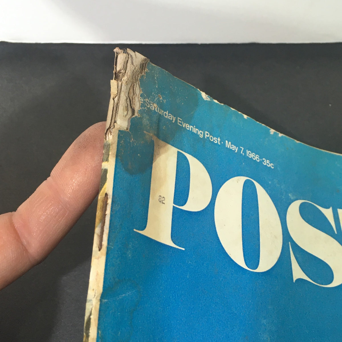 Close-up of the worn edge of the Vintage The Saturday Evening Post magazine from May 7, 1966, showing signs of age and wear.