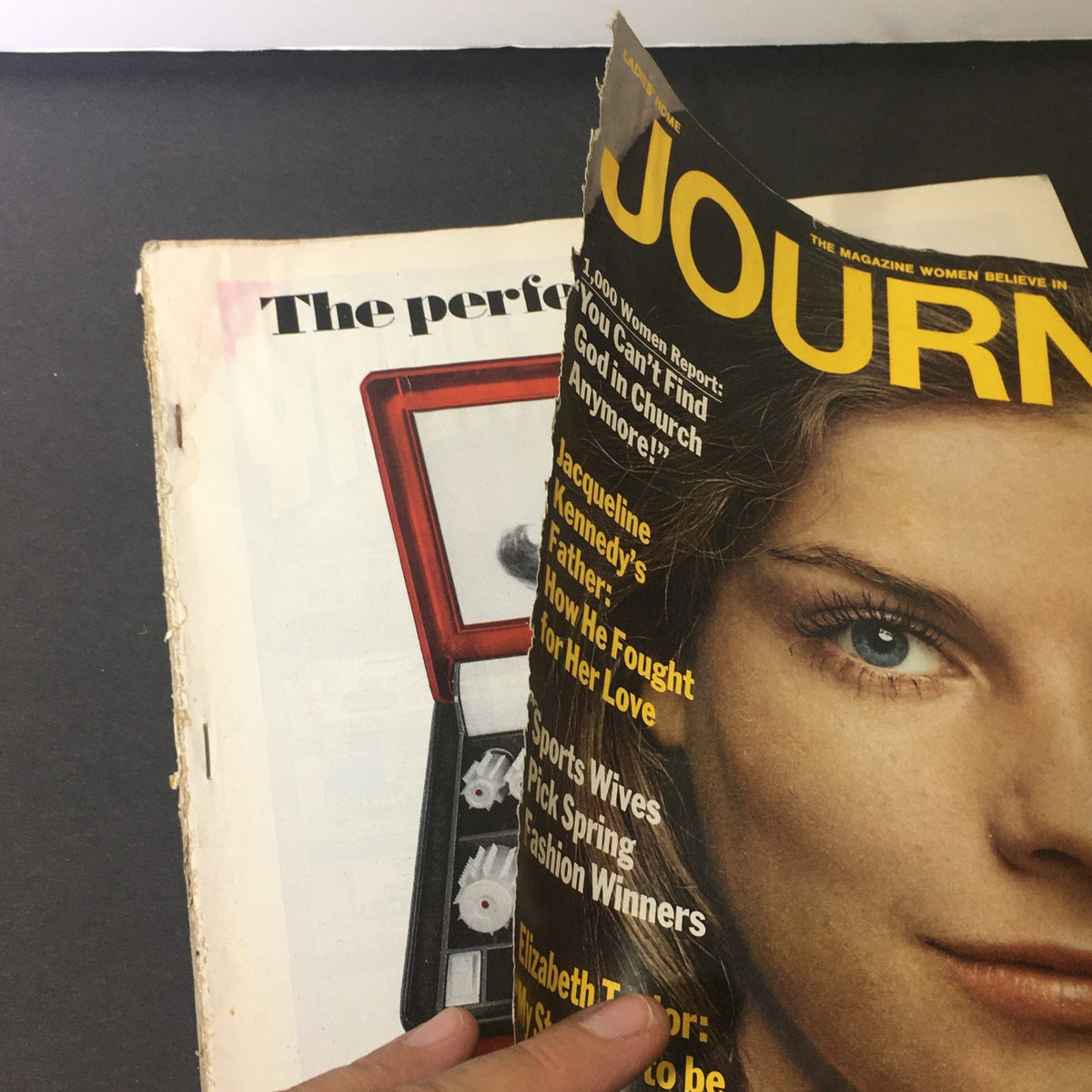 Corner view of the VTG Journal Magazine March 1969 cover showing highlighted text about Jacqueline Kennedy and Elizabeth Taylor along with the magazine's title.