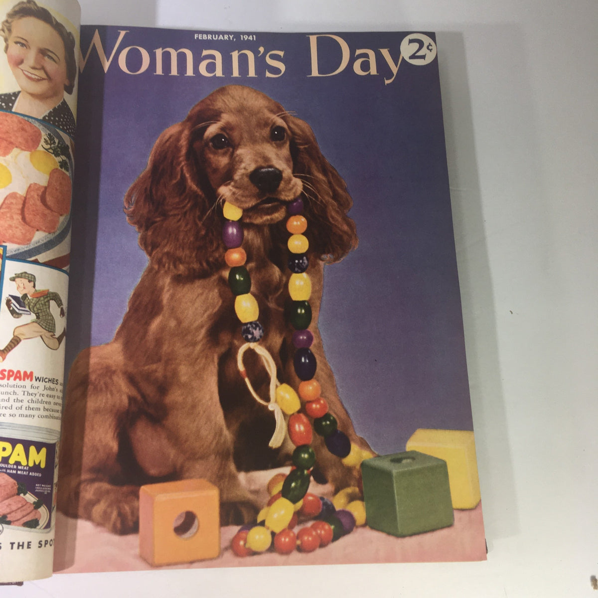 1941 Woman's Day Magazine Compilation highlighting the February cover with a playful cocker spaniel dog wearing colorful beads.