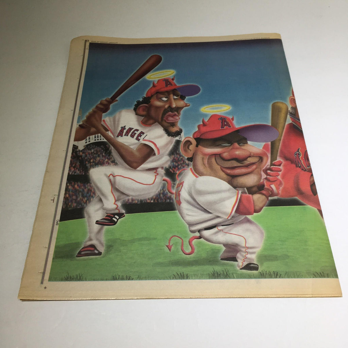 Back cover illustration of NY Daily News from October 15, 2009 showing caricatures of Angels players on a baseball field, titled 'Halo Again: Yanks Ready to Bring Angels Back to Earth'.