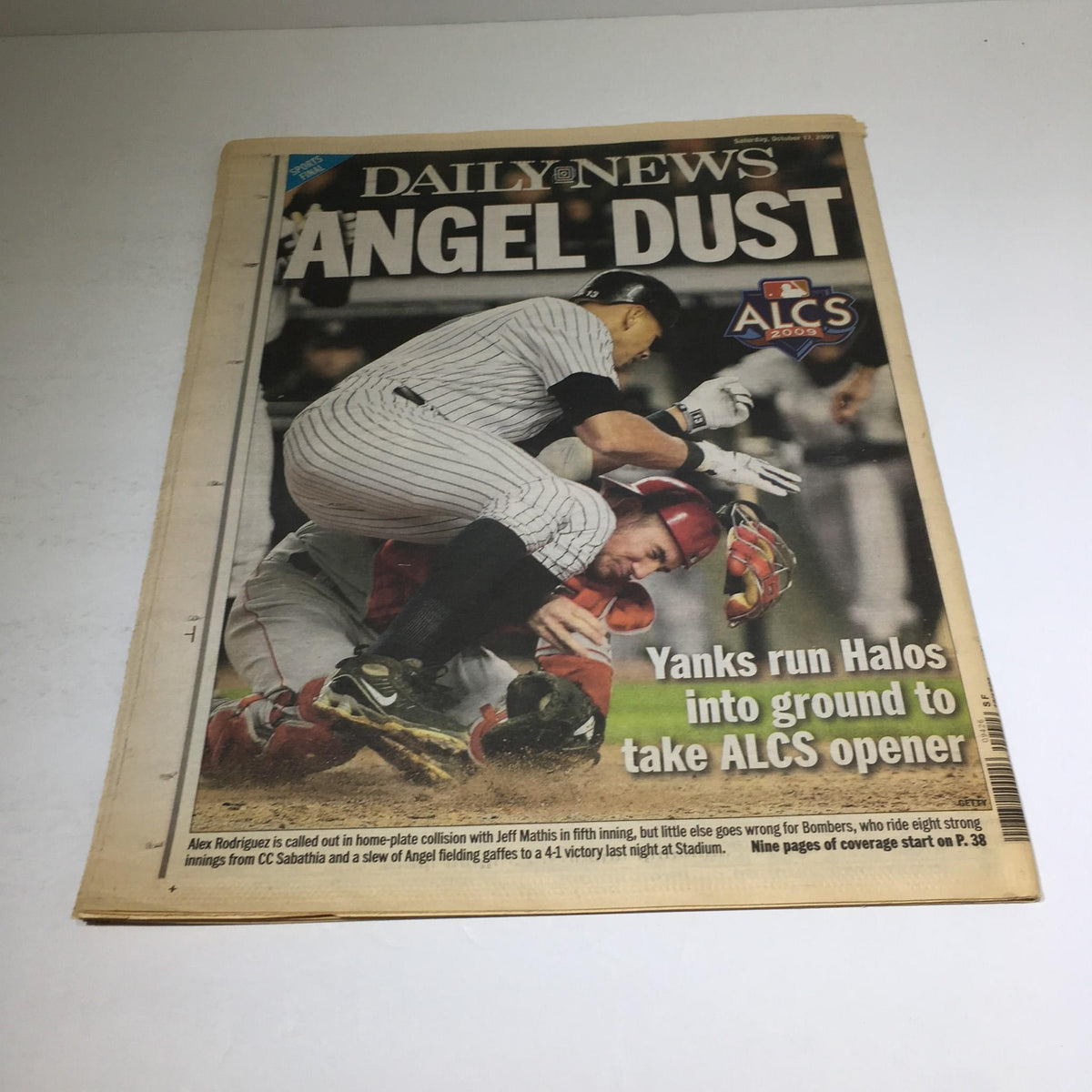 NY Daily News cover titled 'ANGEL DUST' from October 17, 2009, depicting a collision between Yankees and Angels players during the ALCS opener.