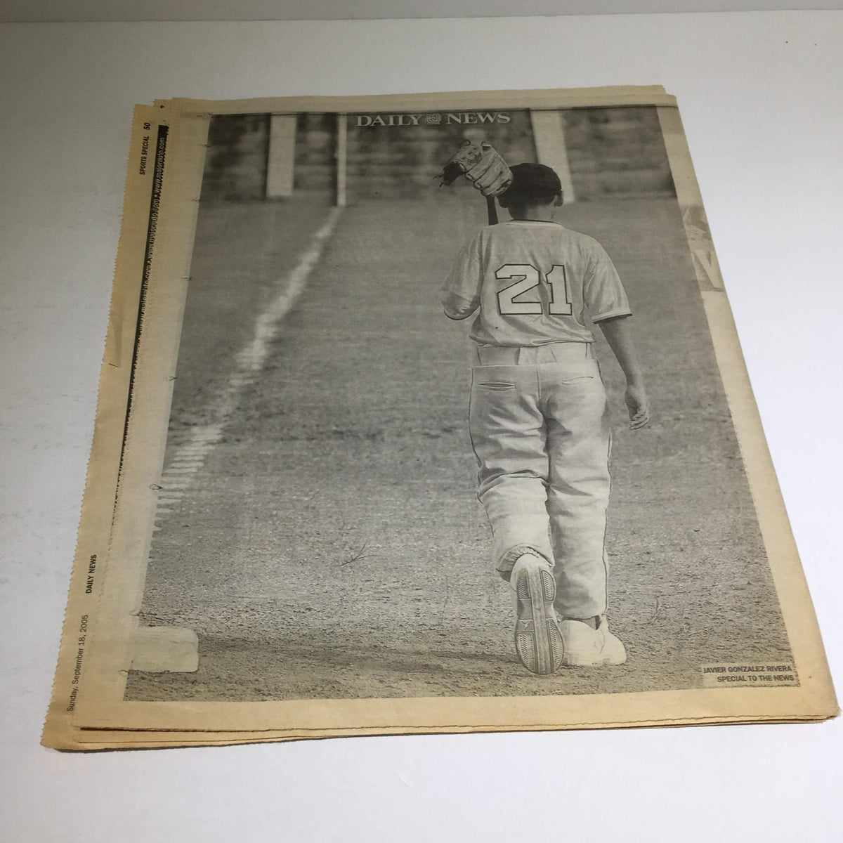 Image showing a young baseball player wearing jersey number 21 from behind, featured in the NY Daily News article 'Viva Baseball 21' on September 18, 2005.