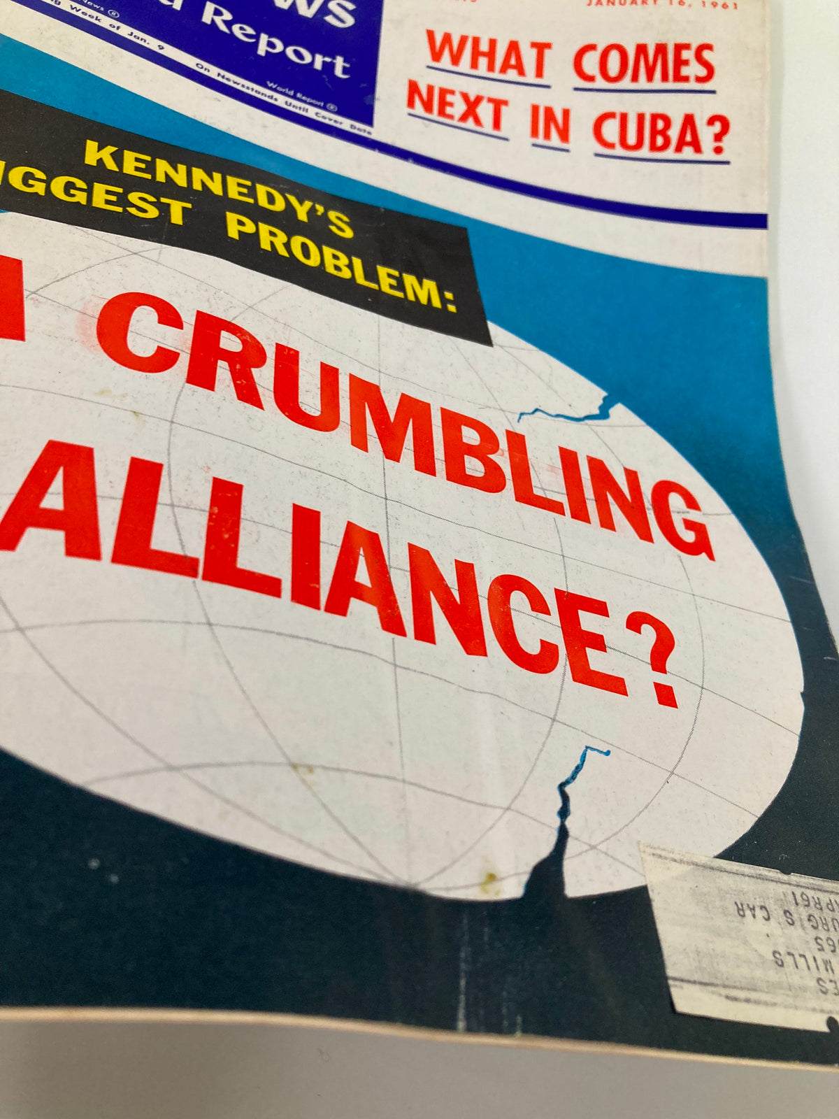 Close-up view of the cover of US News & World Report from January 16, 1961, highlighting the article 'Kennedy's Biggest Problem: A Crumbling Alliance?' with vibrant red text and a graphic image of a globe.