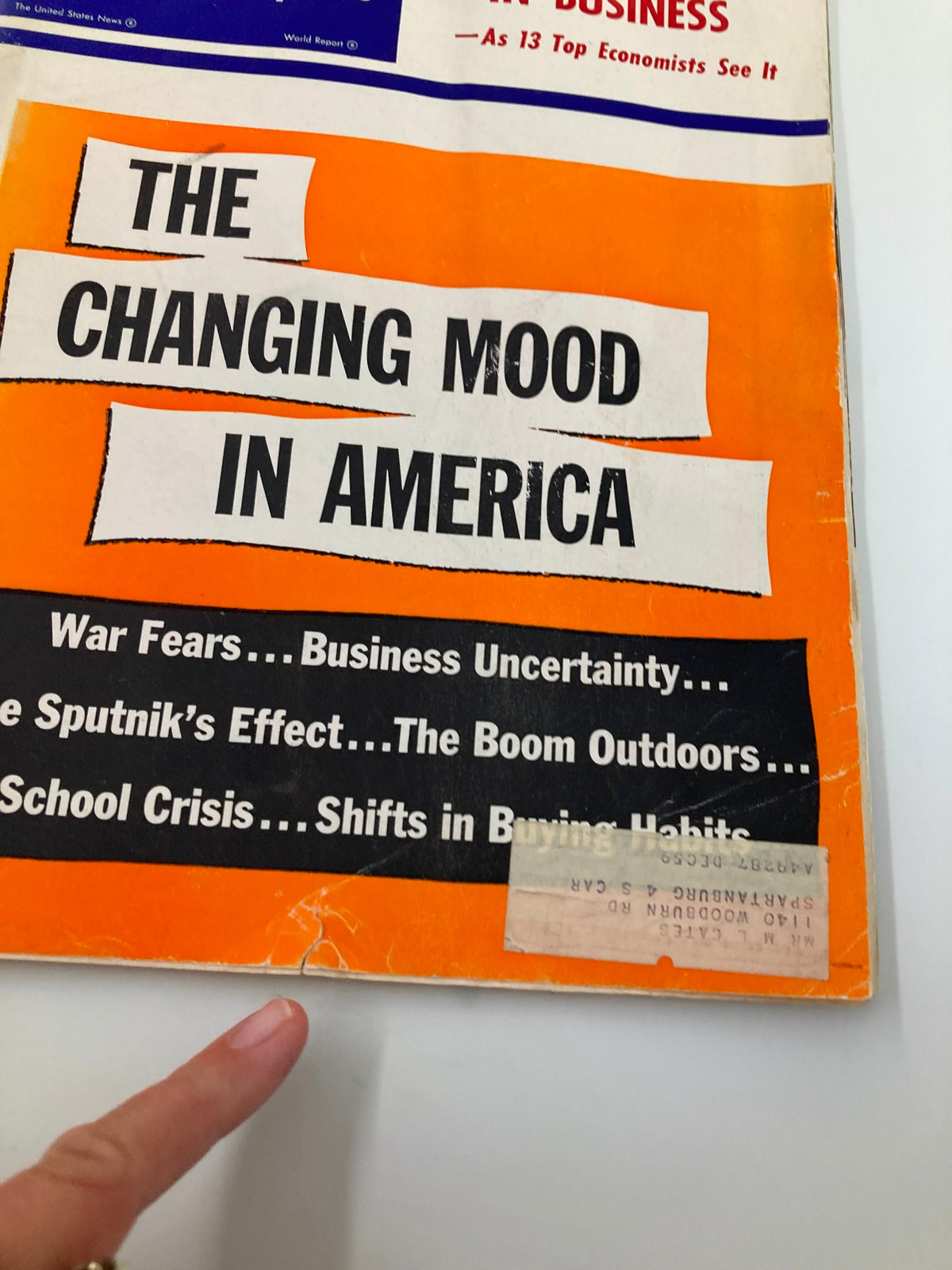 Close-up of the cover of US News & World Report Magazine December 20, 1957, emphasizing the title 'The Changing Mood in America' and textual elements related to business uncertainty and social changes.
