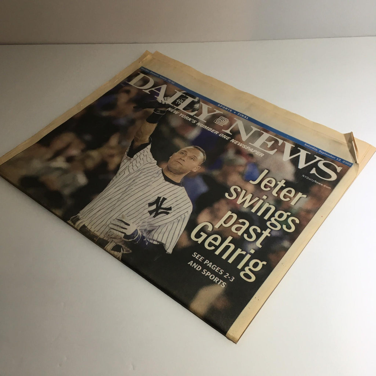 Side view of the NY Daily News from September 12, 2009, with Derek Jeter on the cover, showcasing the newspaper’s prominent headline about his record.