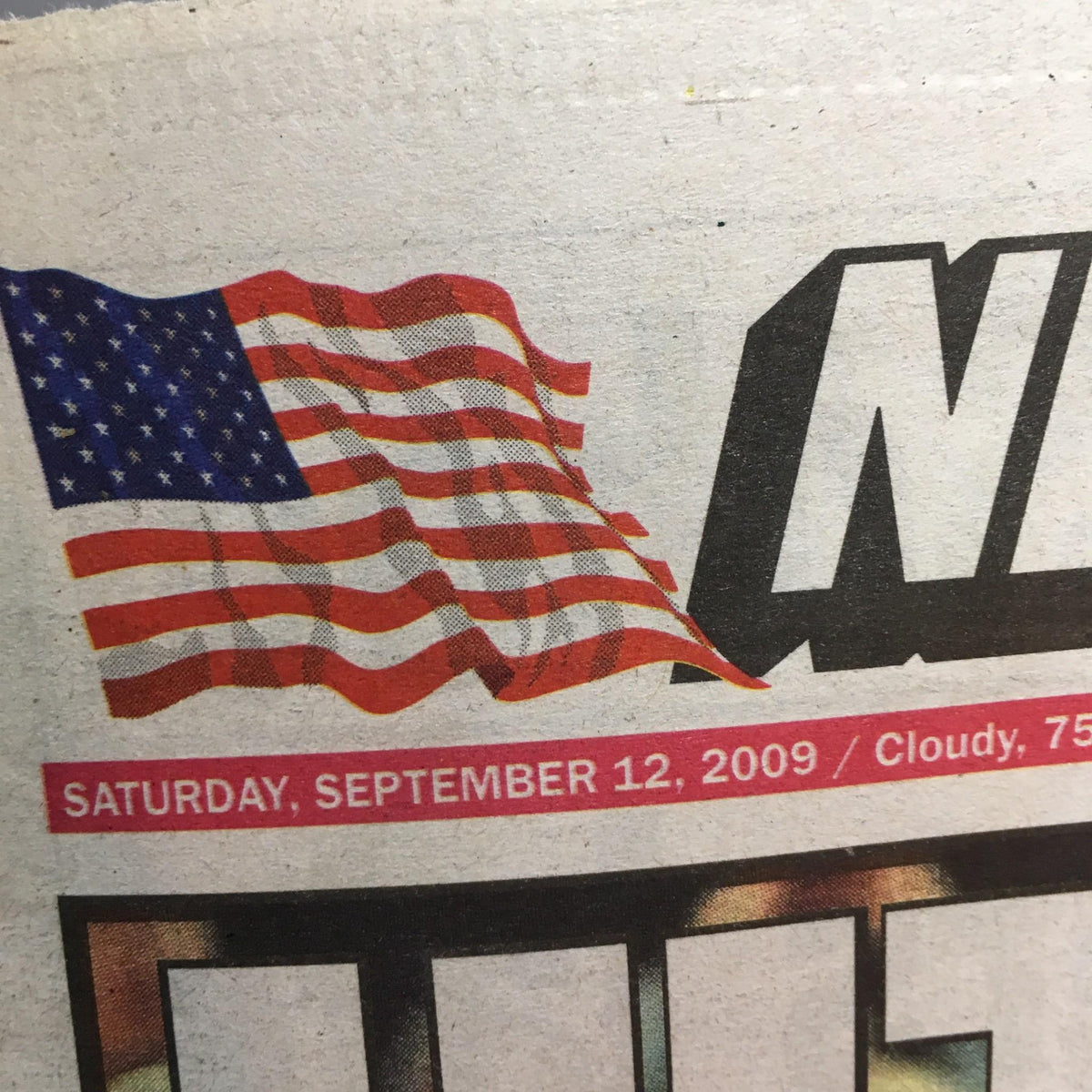 Close-up of NY Post dated September 12, 2009, showcasing American flag and headline related to Derek Jeter.