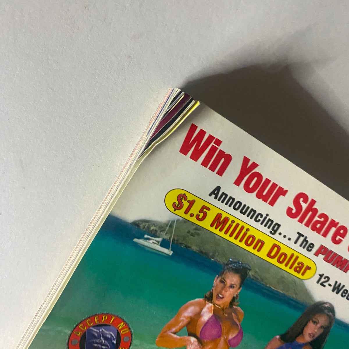 Close-up of the top corner of Pump Magazine May June 1999, highlighting the $1.5 million dollar contest announcement with fitness models on the beach.