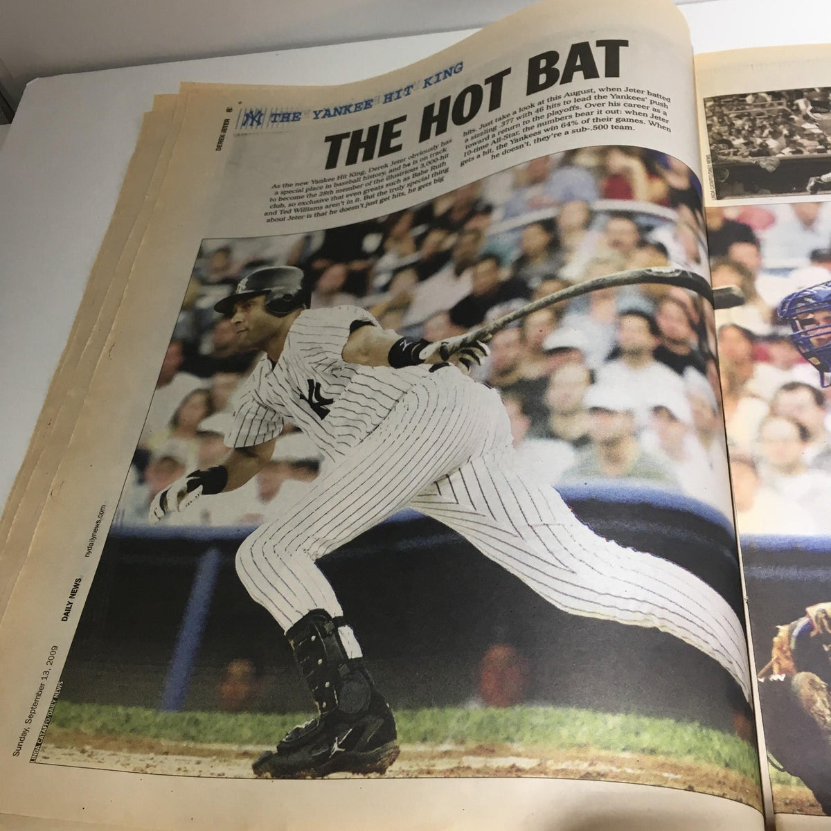 Image from NY Daily News titled 'The King, The Hit, Hot Bat, Early Years Derek Jeter', featuring Derek Jeter in action with a powerful bat swing during a game.