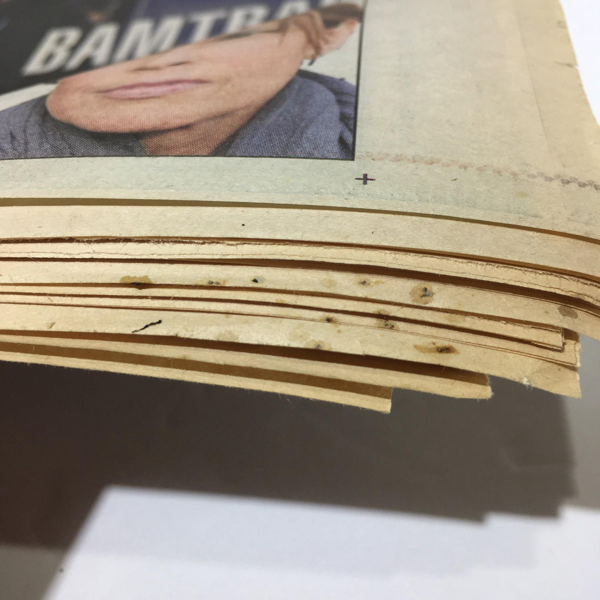 Close-up view of the spine of the New York Daily News, Jan 18 2009, showing age and wear, emphasizing the historic nature of Obama's train ride coverage.