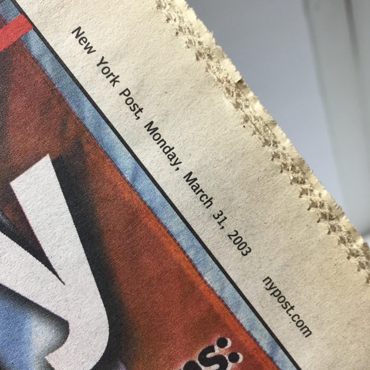 Close-up of the New York Post header showing the date, Monday, March 31, 2003, associated with Old Glory and baseball.