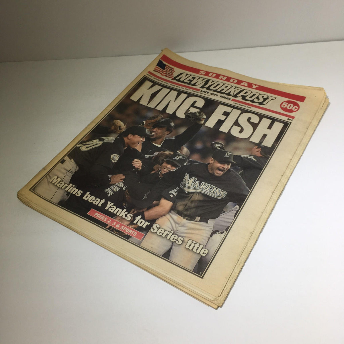 New York Post cover showcasing the headline 'KING FISH' with images of jubilant Marlins players celebrating after defeating the Yankees for the Series title.