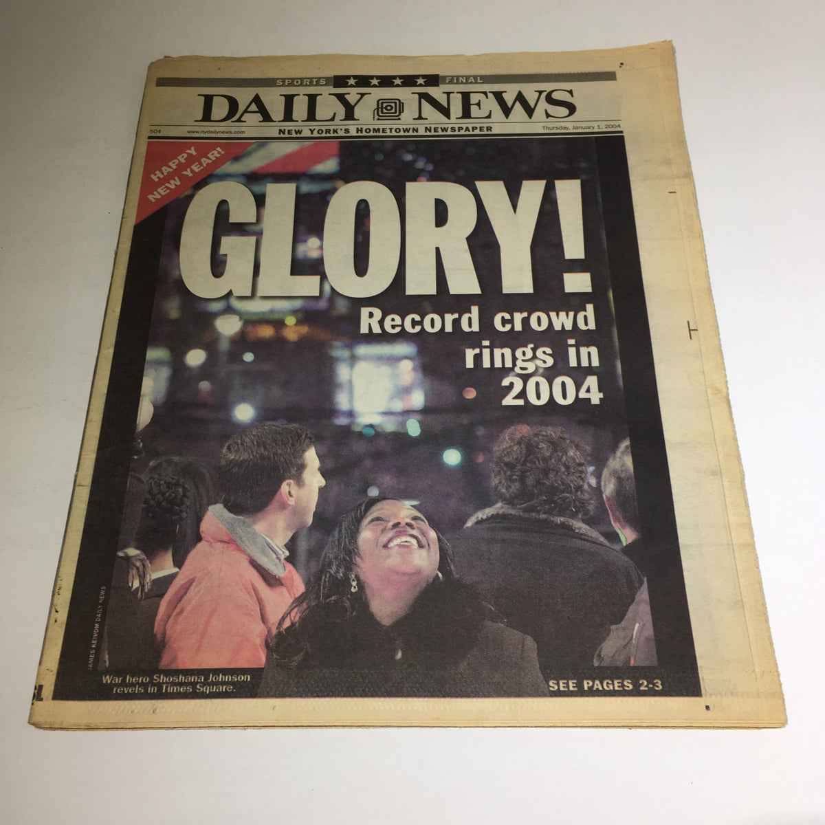 New York Daily News front page featuring the title 'Glory! Record crowd rings in 2004', capturing the excitement of a New Year's celebration with people watching in Times Square.