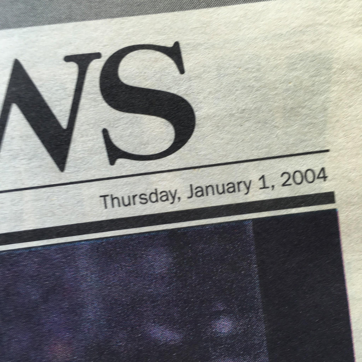 Close-up of the date from the New York Daily News, dated Thursday, January 1, 2004, highlighting the publication date of a significant New Year's edition.