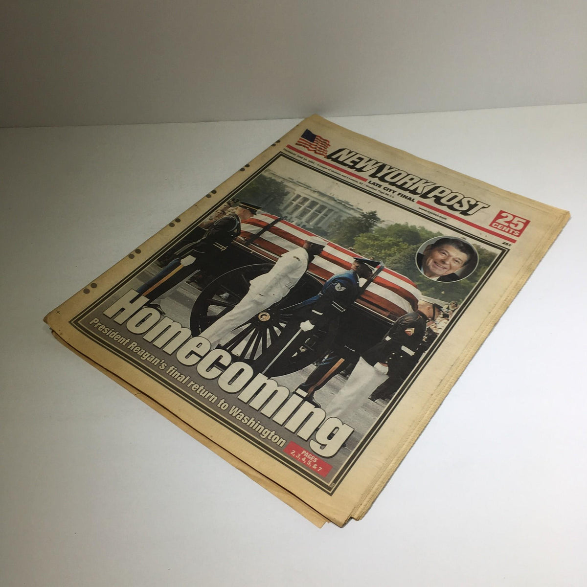 New York Post newspaper from June 10, 2004, featuring the headline 'Homecoming: President Reagan's Final Return to Washington' with an image of the casket and pallbearers.