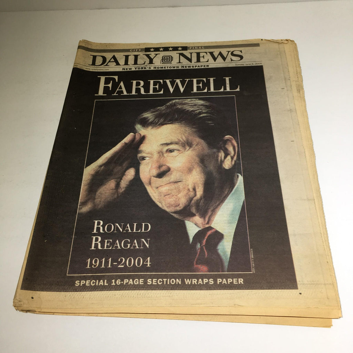 Cover of the New York Daily News from June 6, 2004, featuring a tribute to Ronald Reagan, 1911-2004, with a photograph of Reagan saluting. This commemorative edition reflects on his legacy and is a unique piece of political memorabilia.