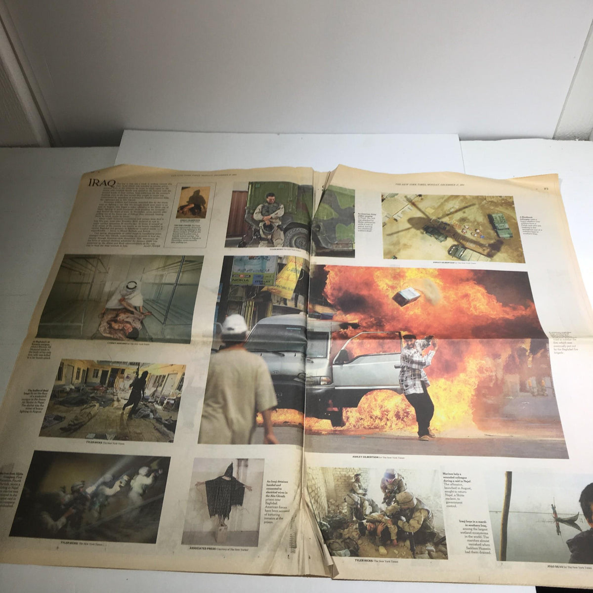 The New York Times: Dec 27 2004, 2004 The Year in Pictures, showcasing powerful images from Iraq, including scenes of conflict and resilience.