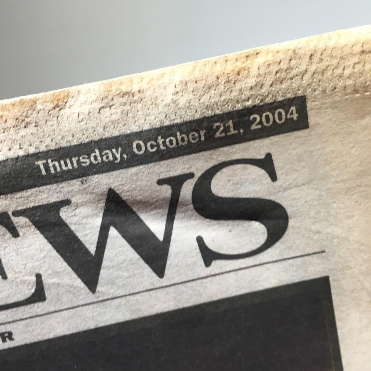 Detail shot of the New York Daily News newspaper header dated Thursday, October 21, 2004, featuring the title 'The Choke's on US', emphasizing its historical significance in sports journalism.