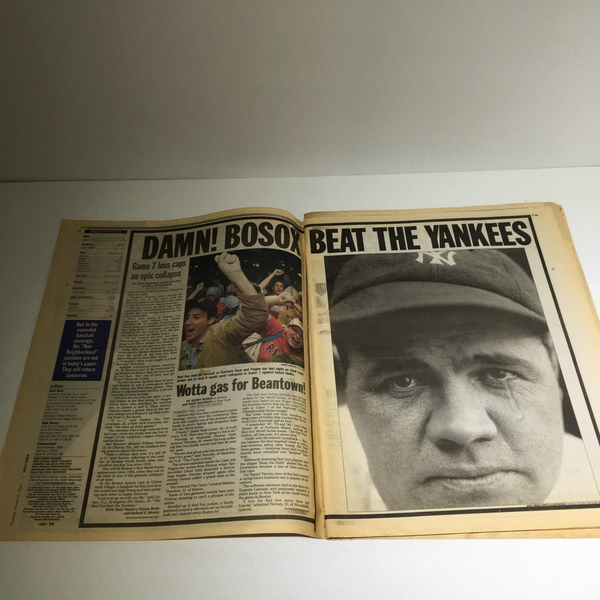 Inside spread of the New York Daily News showcasing the aftermath of the Yankees' loss with the headline 'DAMN! BOSOX BEAT THE YANKEES', reflecting on a historic game.