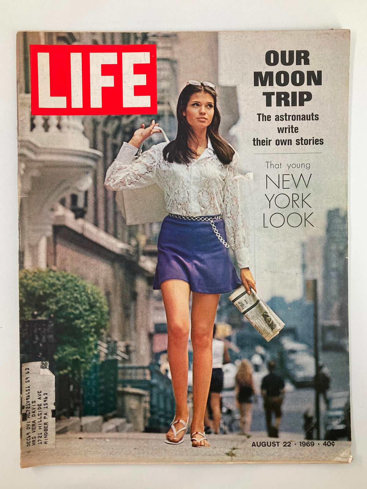 Cover of the vintage Life Magazine from August 22, 1969, featuring the title 'The Astronauts Write Their Own Stories', showcasing a stylish woman in a white blouse and blue skirt walking down a city street, reflecting the fashion of the era.