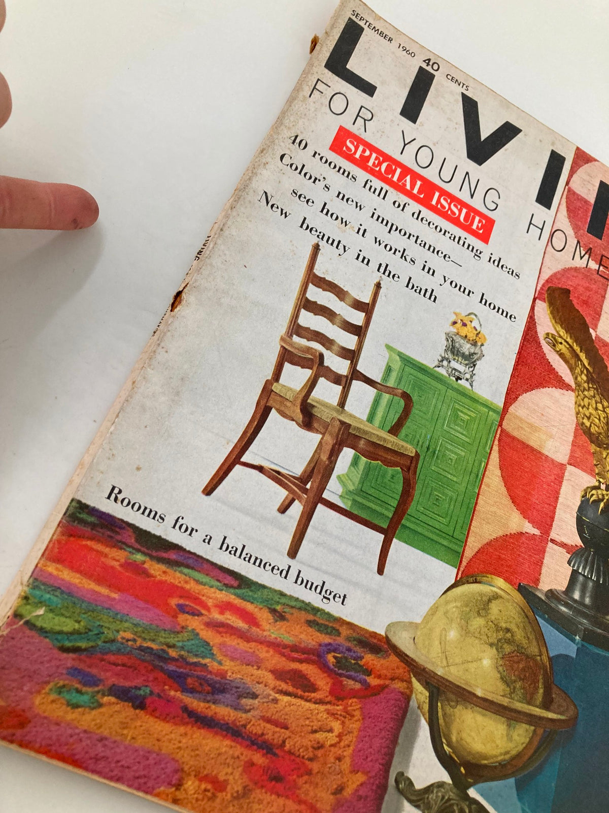 Close-up of the cover of VTG Living for Young Homemakers Magazine September 1960, showcasing colorful design elements and a vintage chair.