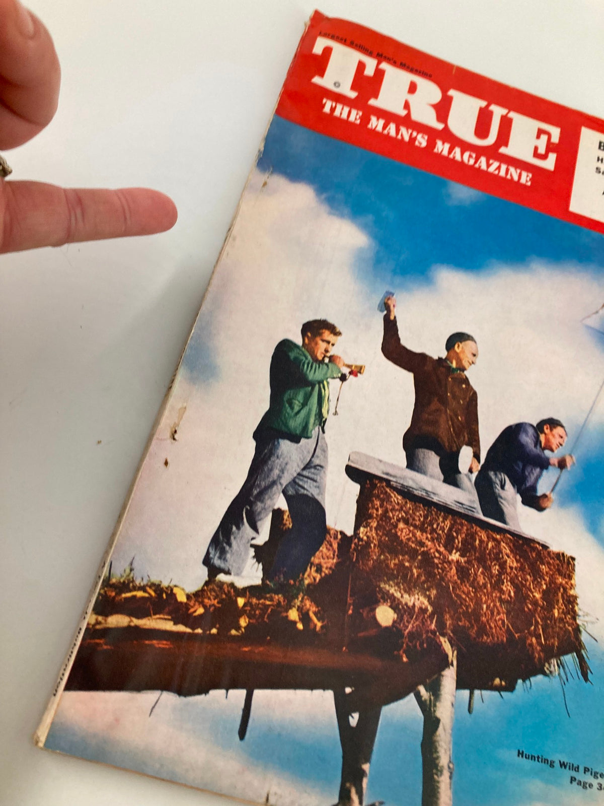 Close-up of the cover of TRUE The Man's Magazine May 1952, showcasing the unique title design and details of the vintage issue featuring men on a hunting platform.