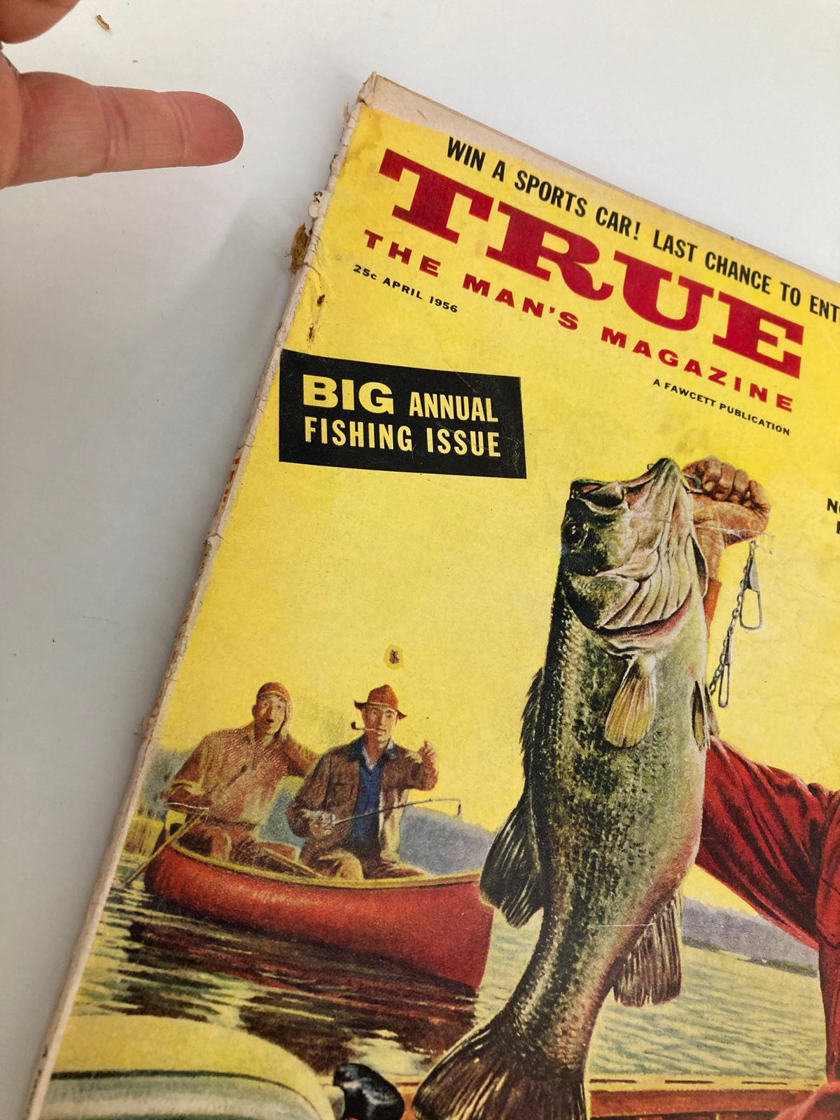 Close-up detail of TRUE The Man's Magazine April 1956 cover highlighting the fishing theme and vintage design elements.