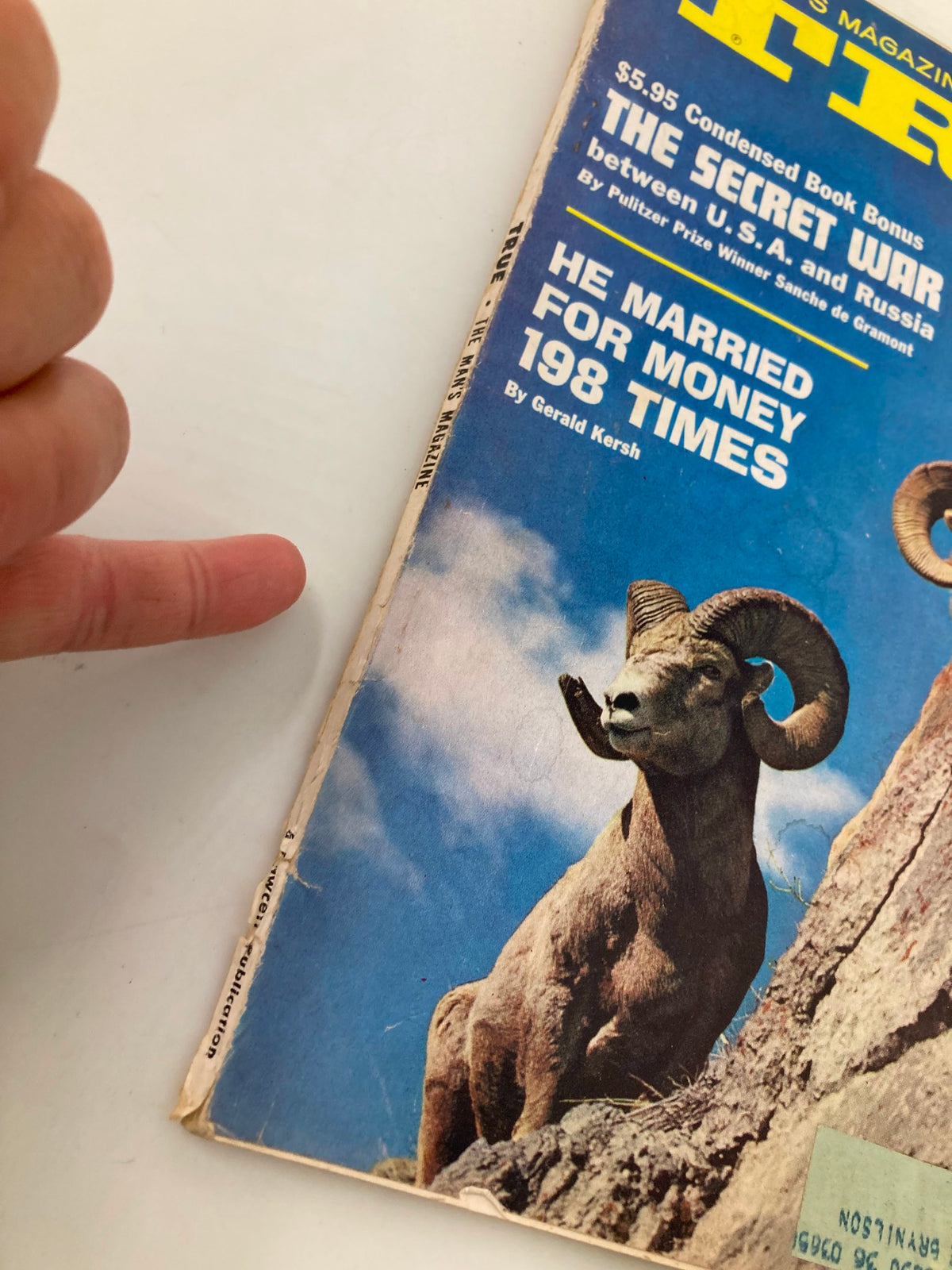 Detailed view of the cover of TRUE The Man's Magazine May 1962, highlighting the title and article titles about the Cold War and personal anecdotes, with a prominent image of a ram.