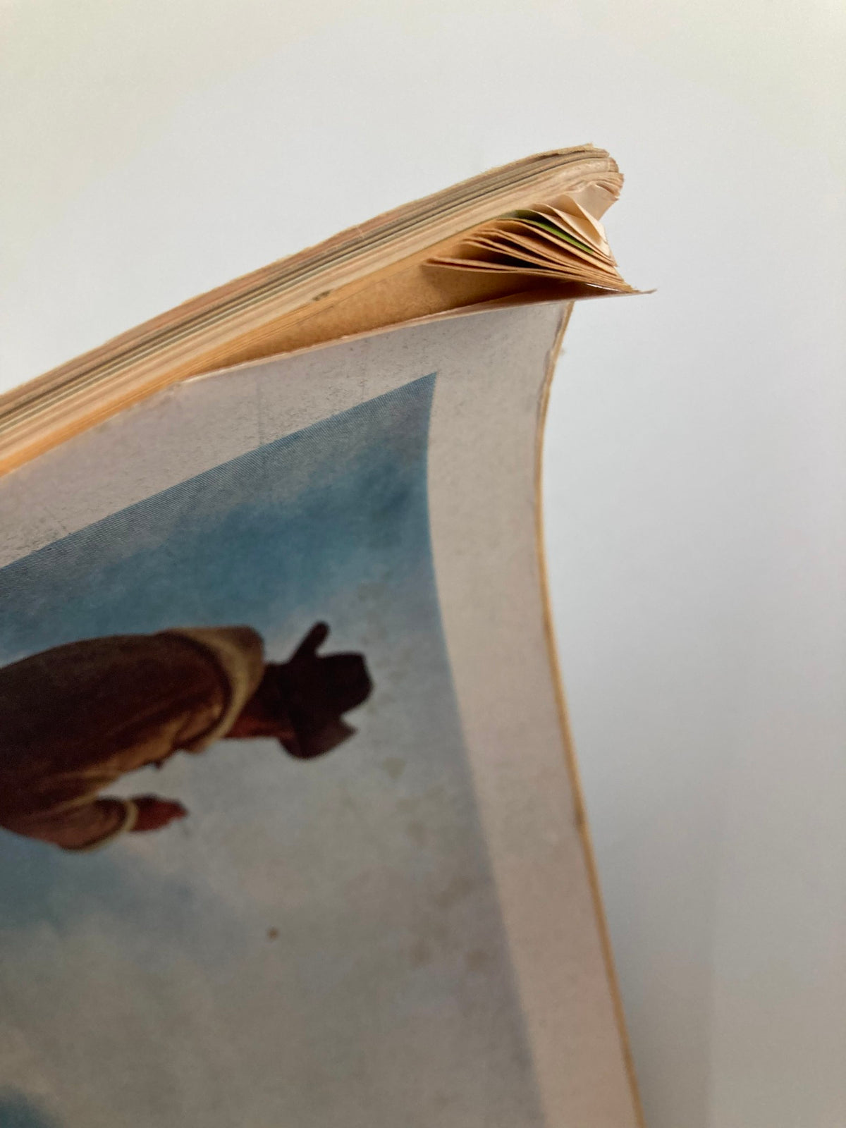 Close-up of the edge of TRUE The Man's Magazine April 1963, highlighting the worn condition of the magazine with some dog-eared pages.