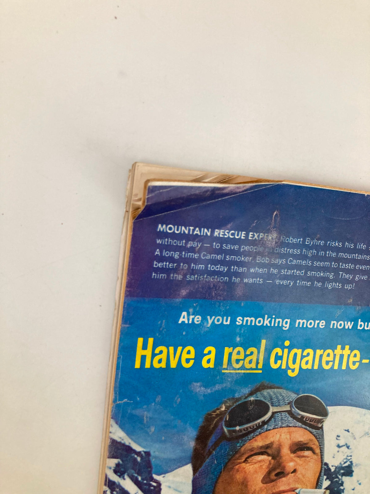Close-up view of the January 1962 issue of TRUE The Man's Magazine, featuring a detailed text section about mountain rescue expert Robert Byhre, showcasing vintage style and advertising related to Camel cigarettes.