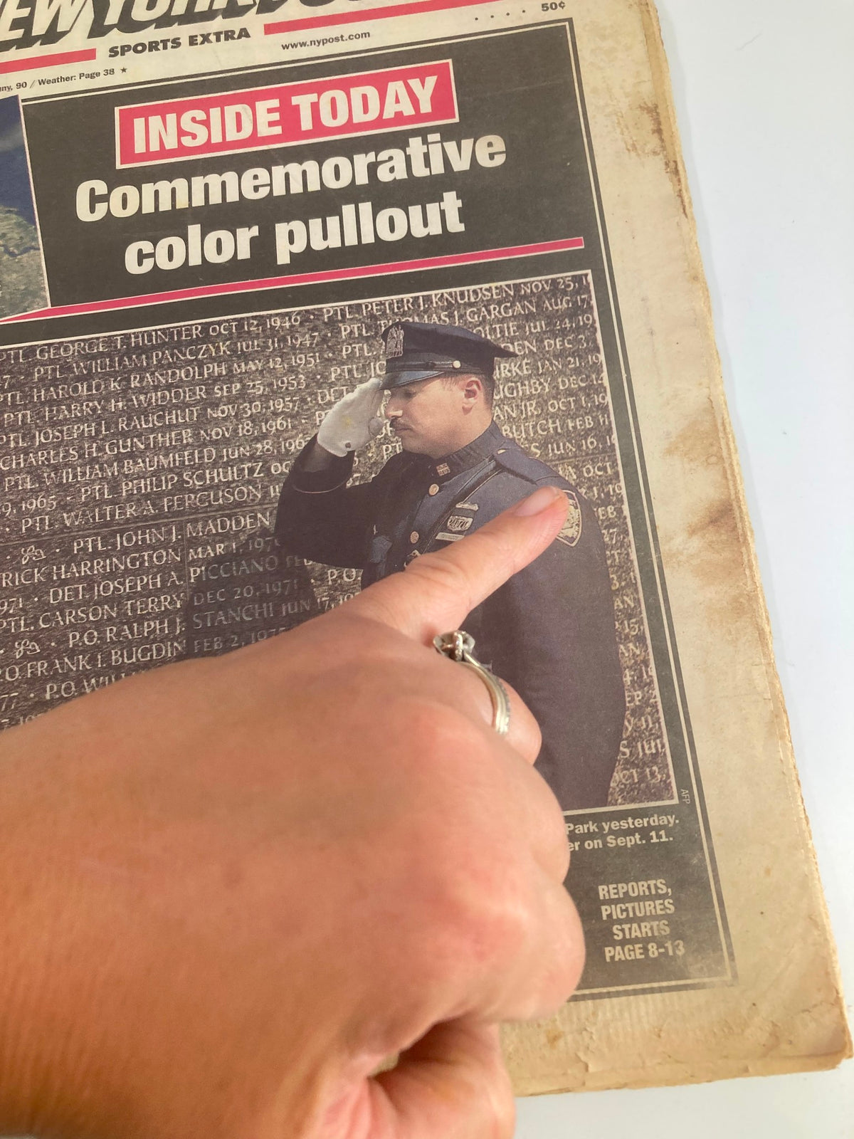 New York Post Newspaper September 10 2002 showing a close-up of a police officer saluting, highlighting the commemorative color pullout for the Police Memorial at Battery Park.