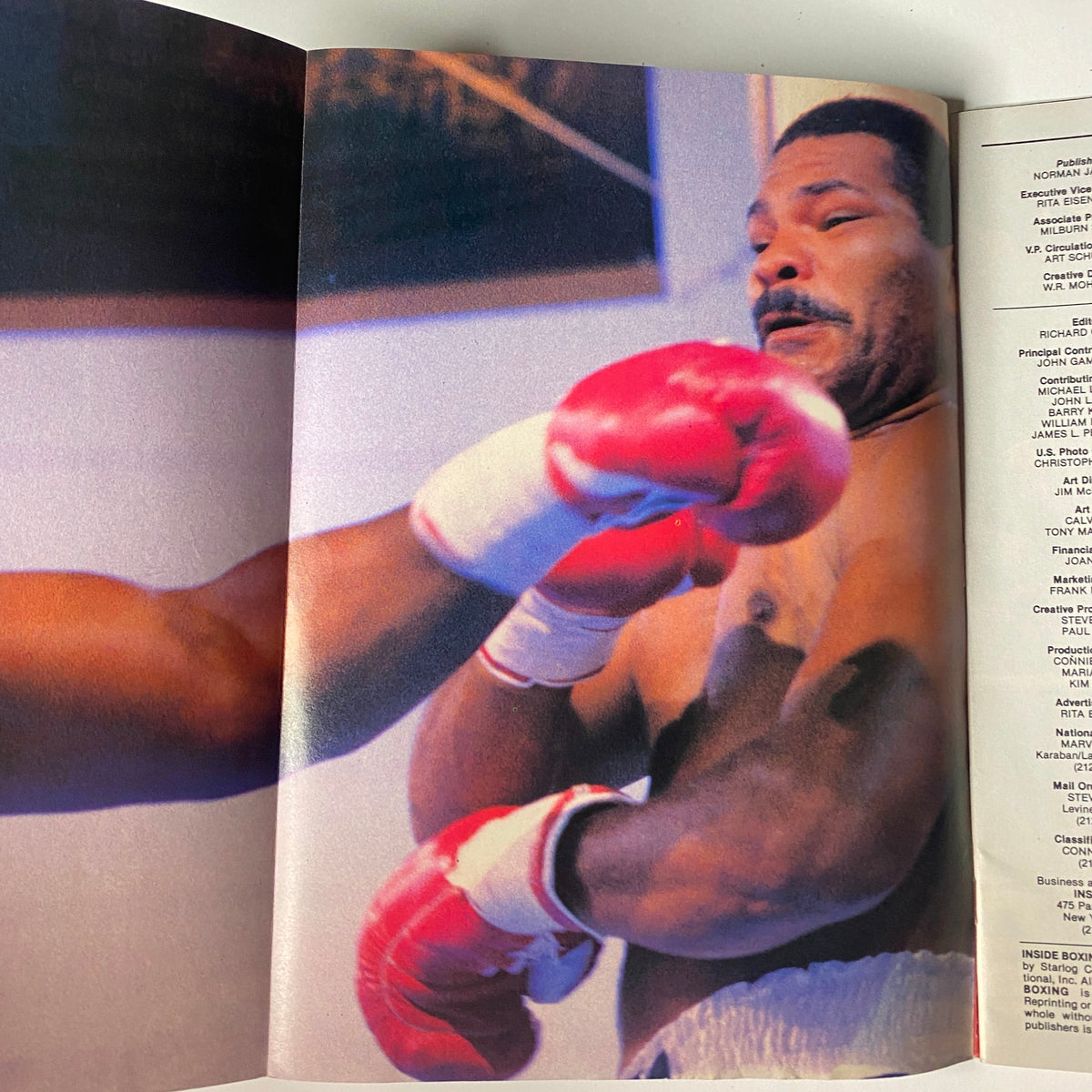 Inside Boxing Magazine No. 4 capturing a close-up moment of a boxer receiving a punch, illustrating the action-packed nature of the sport.