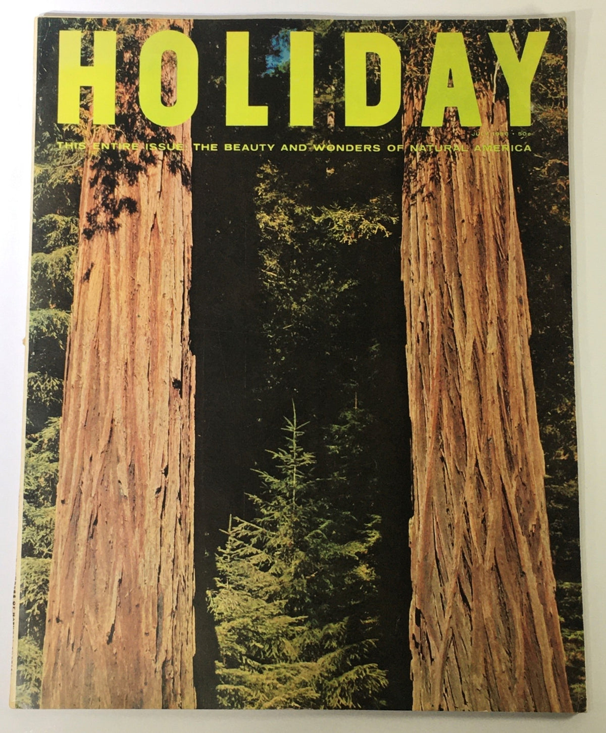Cover of the vintage July 1958 Holiday Magazine showcasing the theme 'The Beauty and Wonders of Natural America' with a stunning natural landscape featuring tall trees.