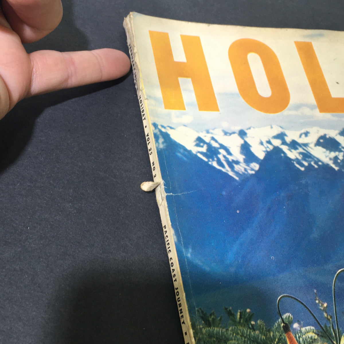Side view of the VTG Holiday Magazine February 1959, showing details of the cover and the binding with visible wear, illustrating its vintage character.