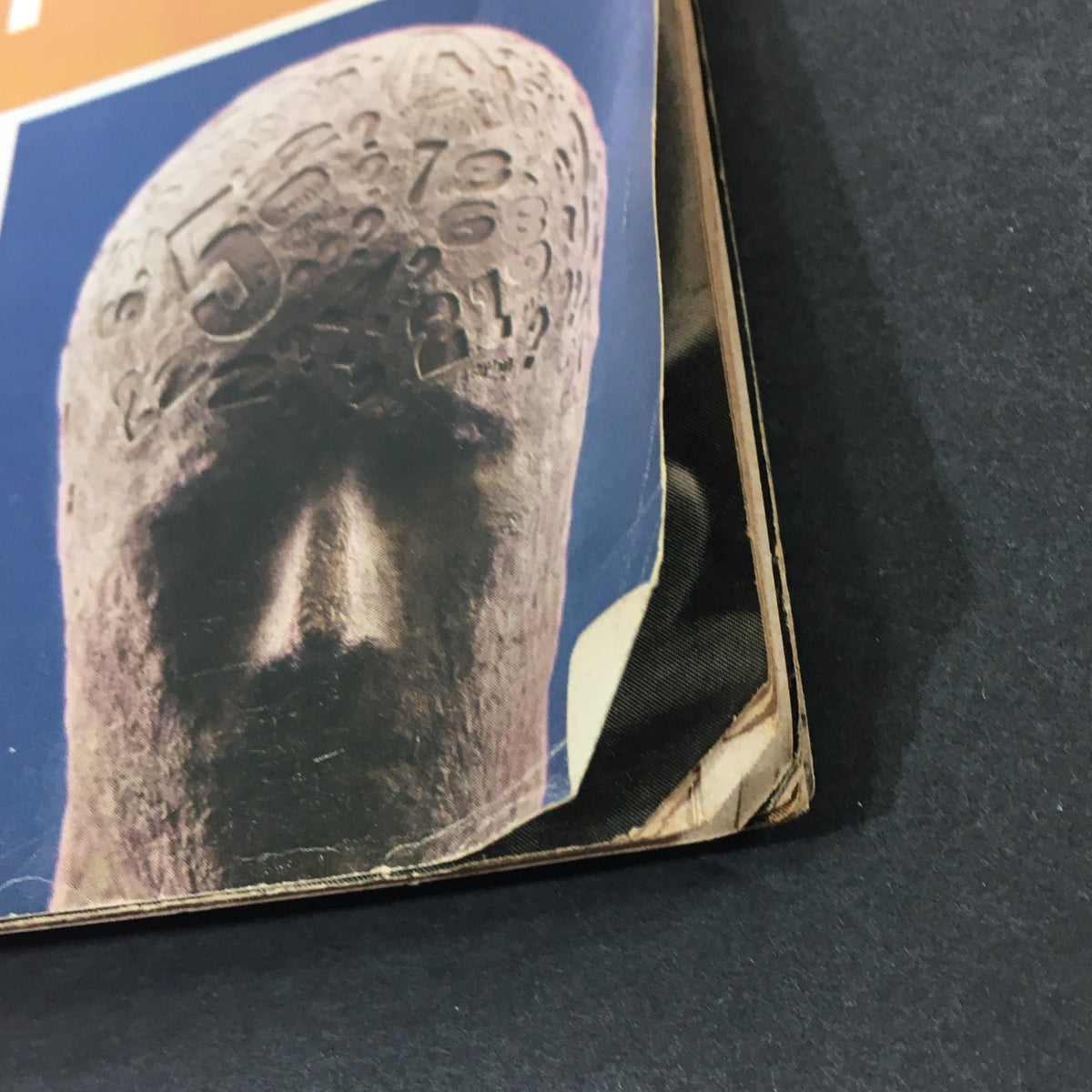 Close-up of the lower corner of the VTG Look Magazine January 12, 1965 cover, highlighting a sculpted head with numbers, part of the 'Inside the Twentieth Century' theme by John Gunther.