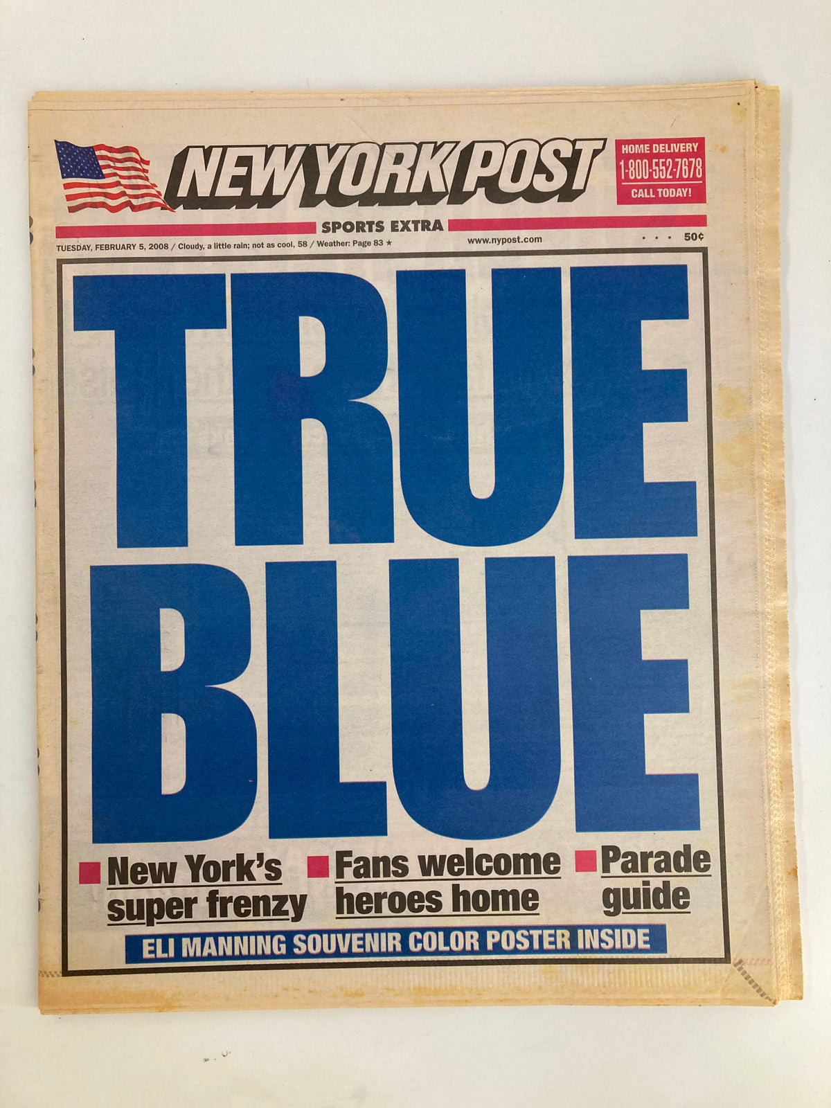 New York Post newspaper from February 5, 2008, featuring the headline 'TRUE BLUE', highlighting New York's super frenzy with a color poster of Eli Manning included inside.