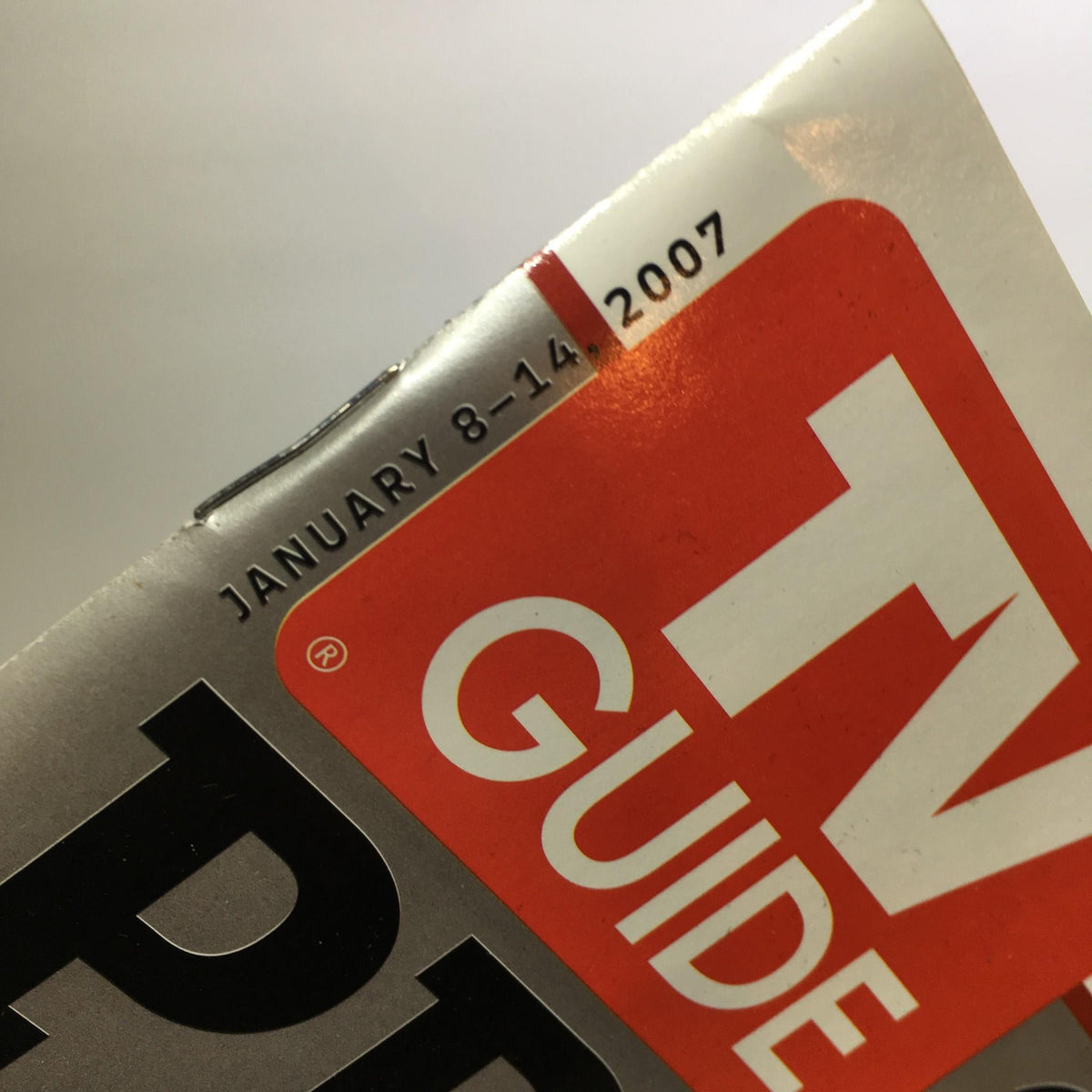 Close-up of the TV Guide January 8-14 2007 showing the publication date on the spine, highlighting its features and relevance to popular TV shows such as Heroes, Lost, and Prison Break.