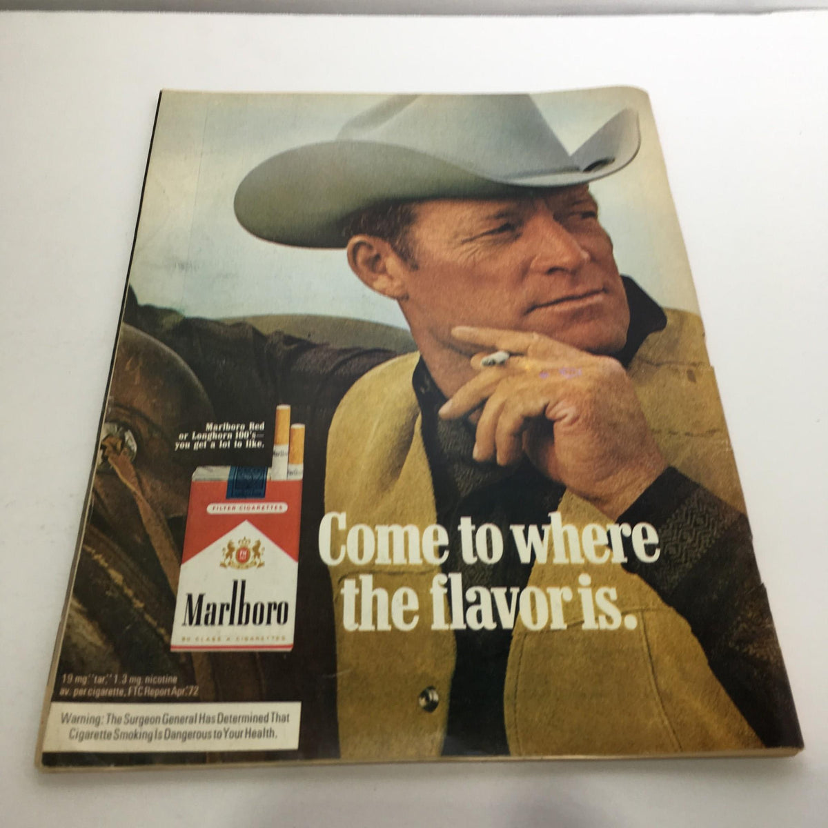 Vintage advertisement for Marlboro cigarettes featuring a rugged cowboy, associated with pop culture from the 1970s, in Time Magazine July 3, 1972.
