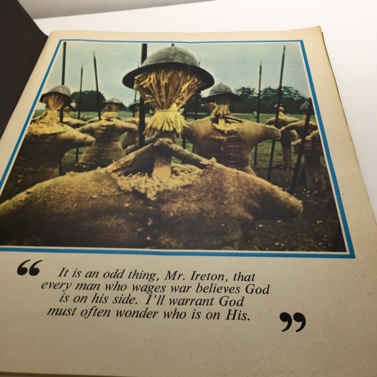 An interior page from Cromwell Magazine by Dr. Maurice Ashley displaying an image of scarecrow-like figures with the quote discussing the philosophical aspects of war, enhancing the magazine's exploration of historical narratives.